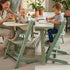 Collage of a family using Growwithme Embo+ mint green children's chair at a dining table.